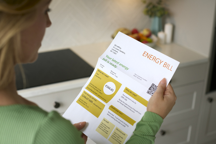 close up of woman opening euro energy bill during cost of living crisis