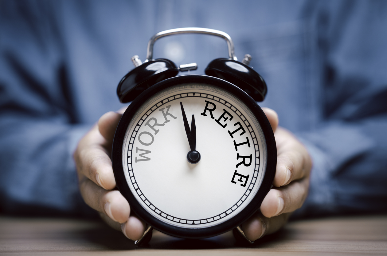 businessman holding black alarm clock with clockwise countdown from work to retirement.