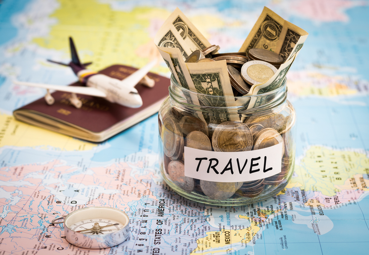 travel budget concept with compass, passport and aircraft toy