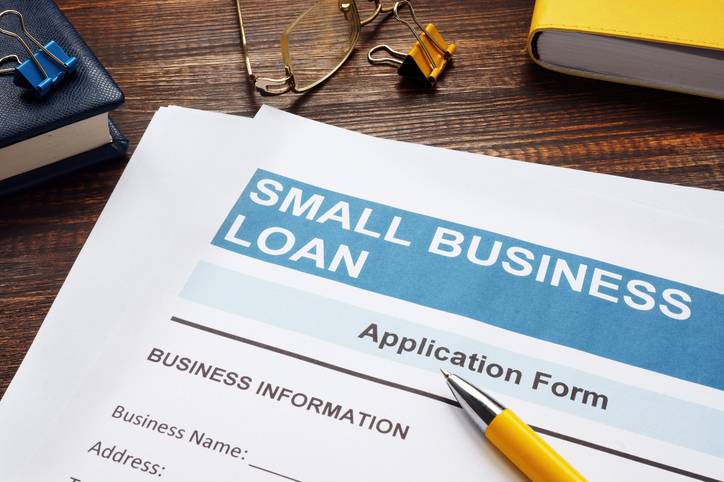 small business loan application on the wooden surface and papers.