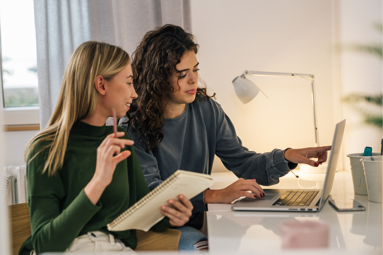 caucasian female students in dorm room