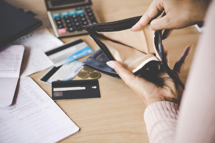 woman hand open empty purse looking for money having problem bankrupt broke