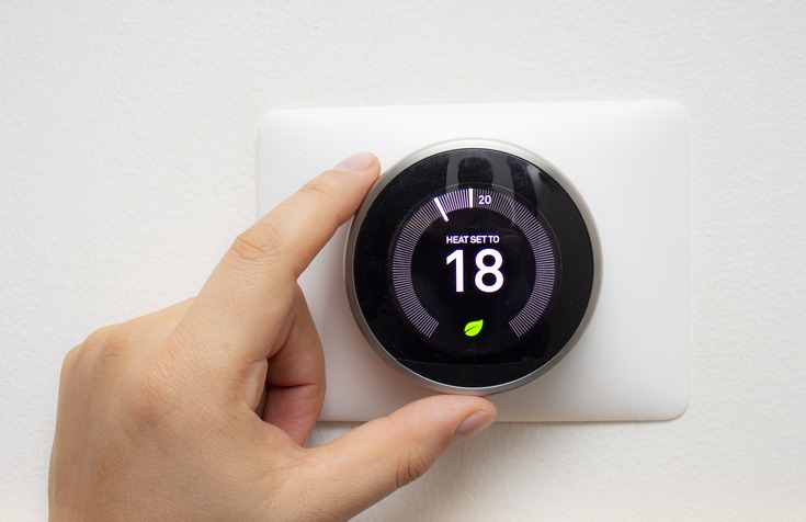 smart thermostat with a person saving energy with a soft shadow