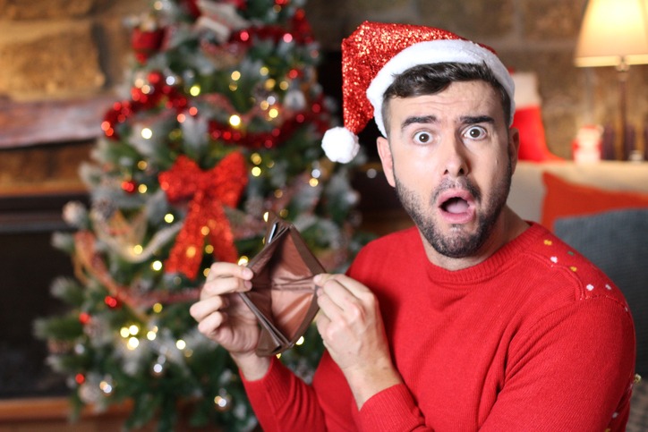 man with empty wallet during christmas