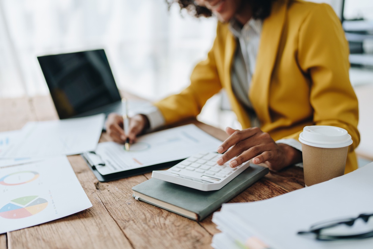 young asian female work with financial papers at home count on calculator before paying taxes receipts online, planning budget glad to find chance for economy saving money, audit concepts.