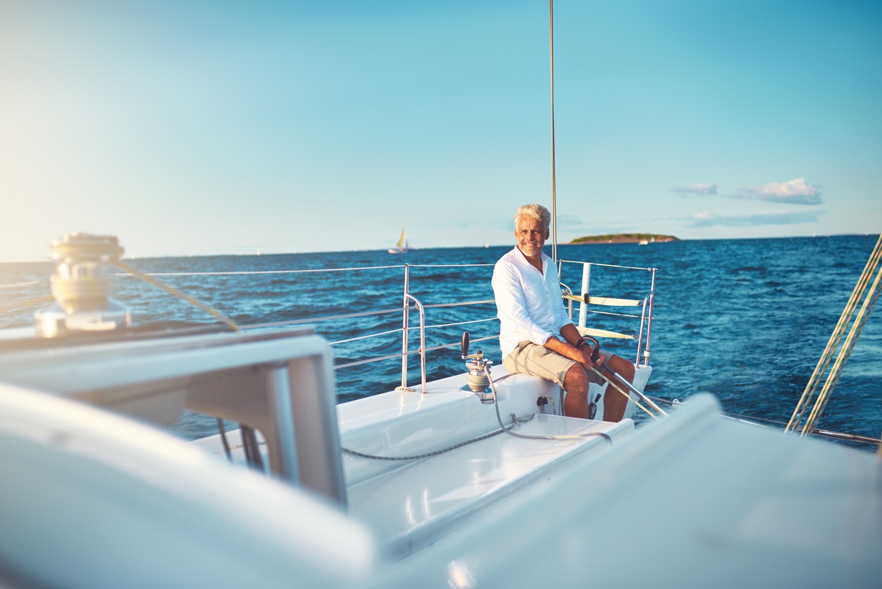 mature man sitting on his boat out at sea