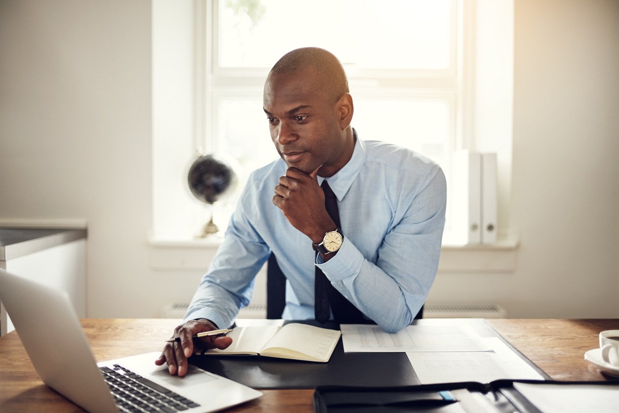 young businessman working on a laptop in an office