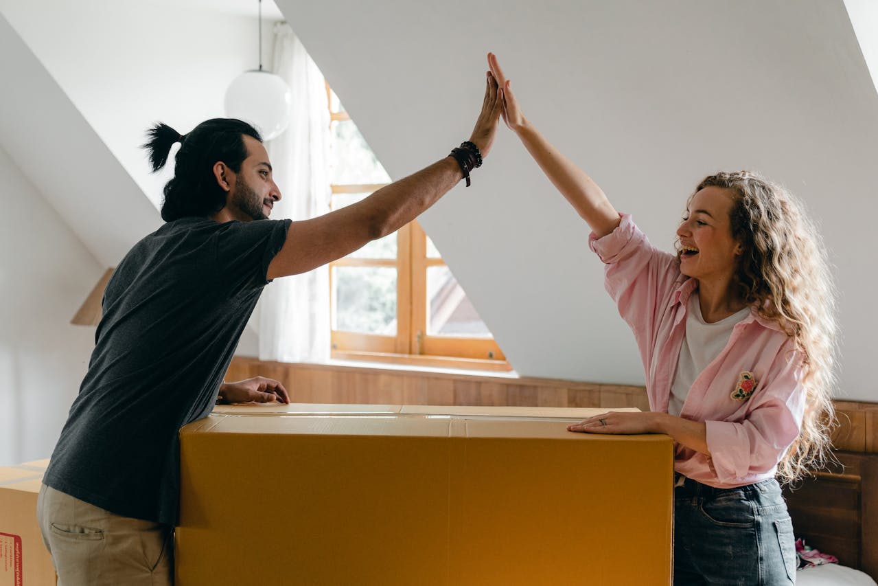 Excited diverse couple relocating in new apartment