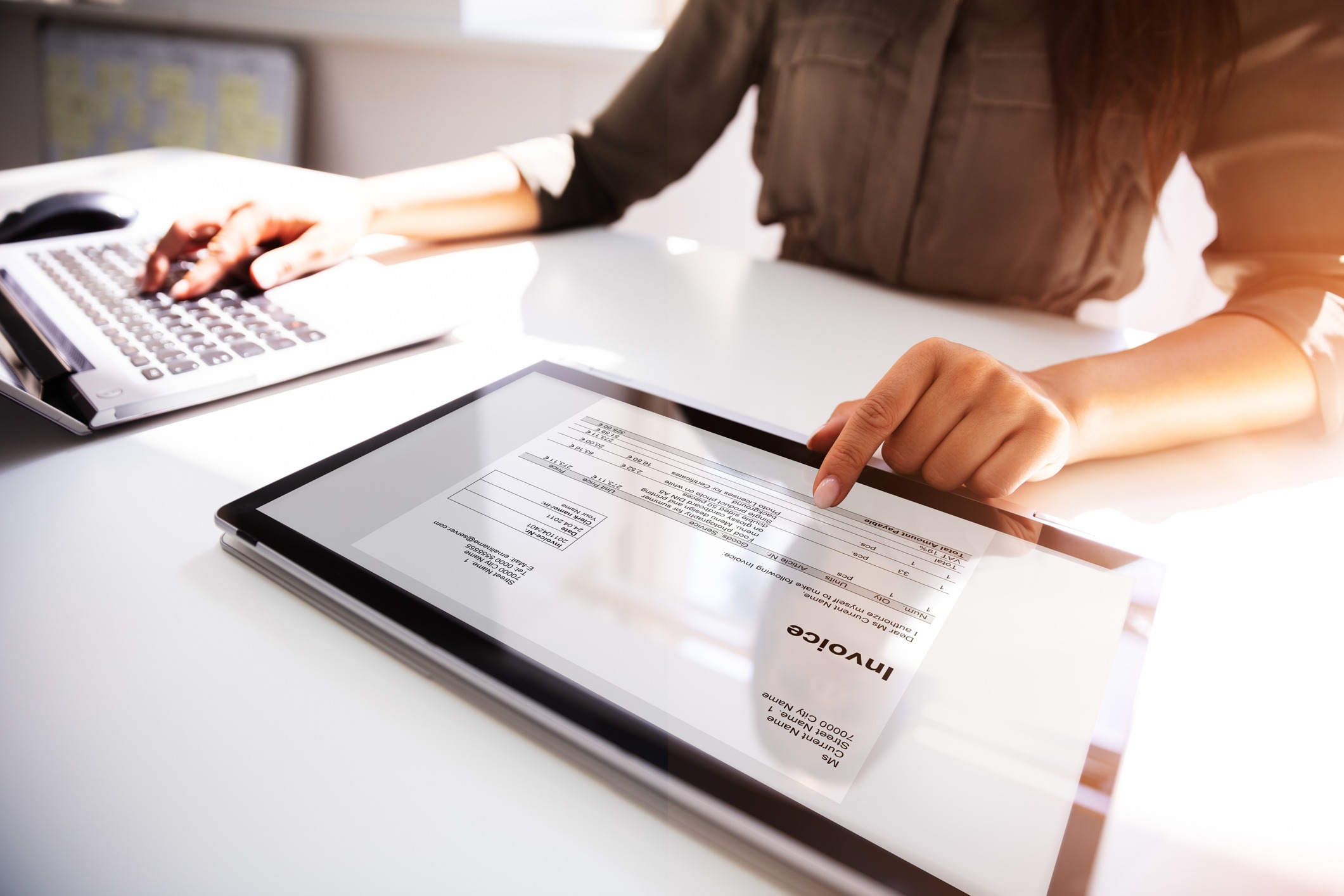 businesswoman checking invoice on digital tablet