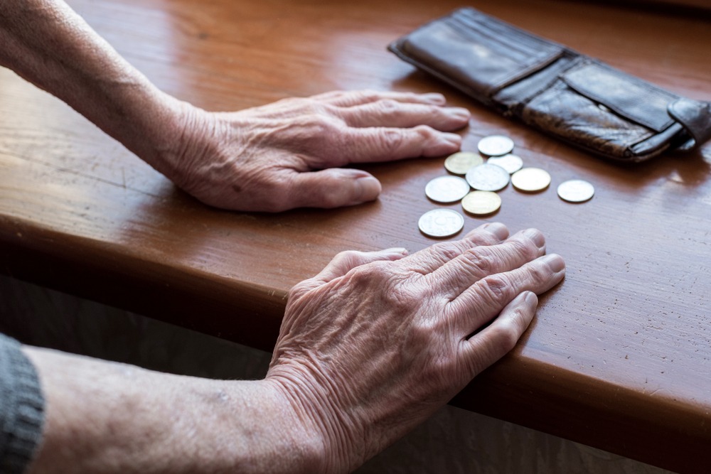 the,hands,of,an,old,woman,counting,money.,poverty,,austerity,