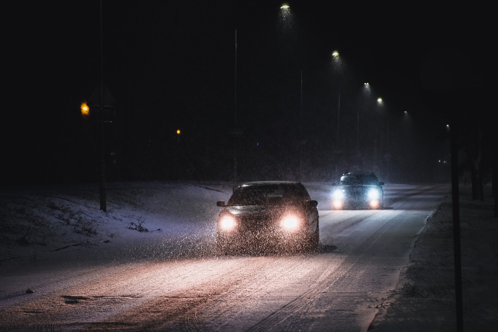 cars,in,a,snowstorm,at,night,on,the,road,in