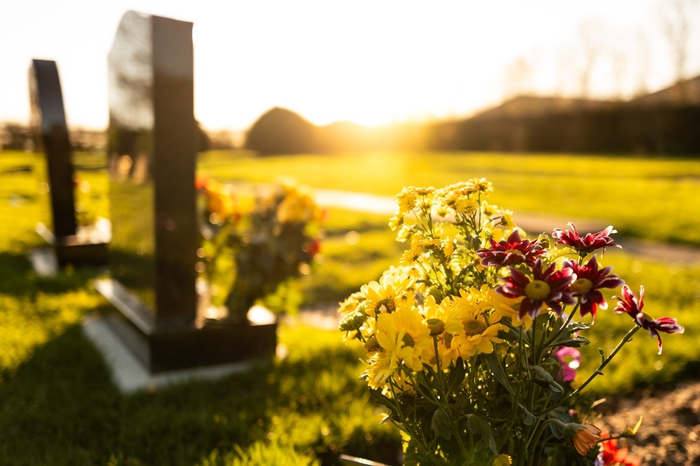 dusk,at,a,winter's,english,cemetery,seen,with,in focus,flowers