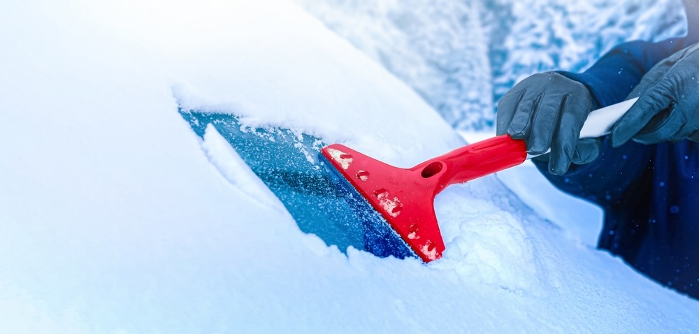 hands,in,gloves,clearing,and,remove,snow,from,windshield,,car