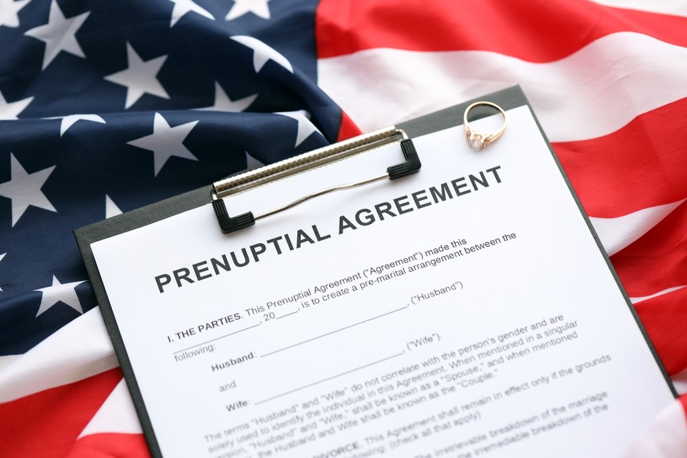 prenuptial,agreement,and,wedding,ring,on,table.,premarital,paperwork,process