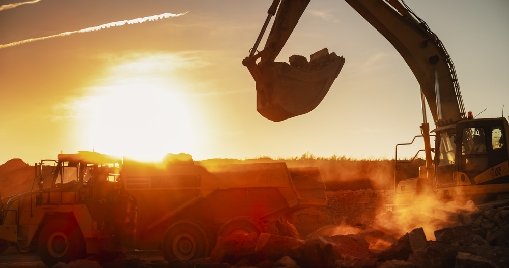 construction,site,on,sunny,evening:,industrial,excavator,loading,rocks,into