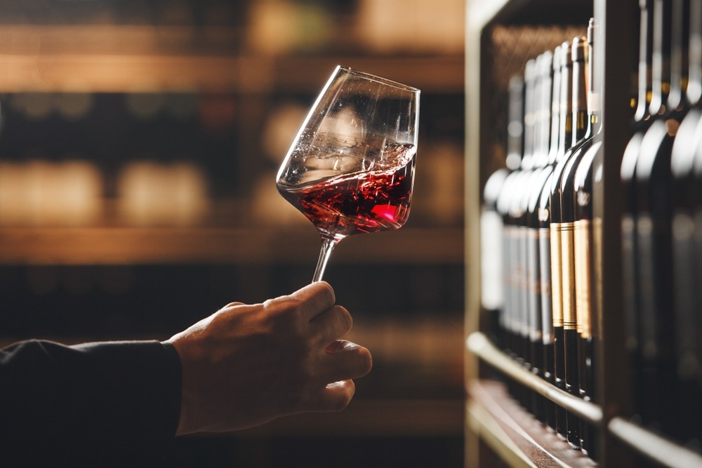 close up,view,of,sommelier,evaluating,red,wine,in,cellar