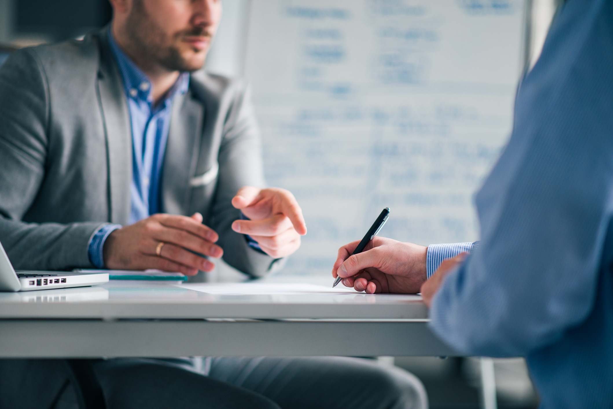 business people negotiating, signing a contract, close up.